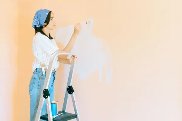 Interior painting in Santa Rosa: painter on a stepladder rolling a wall